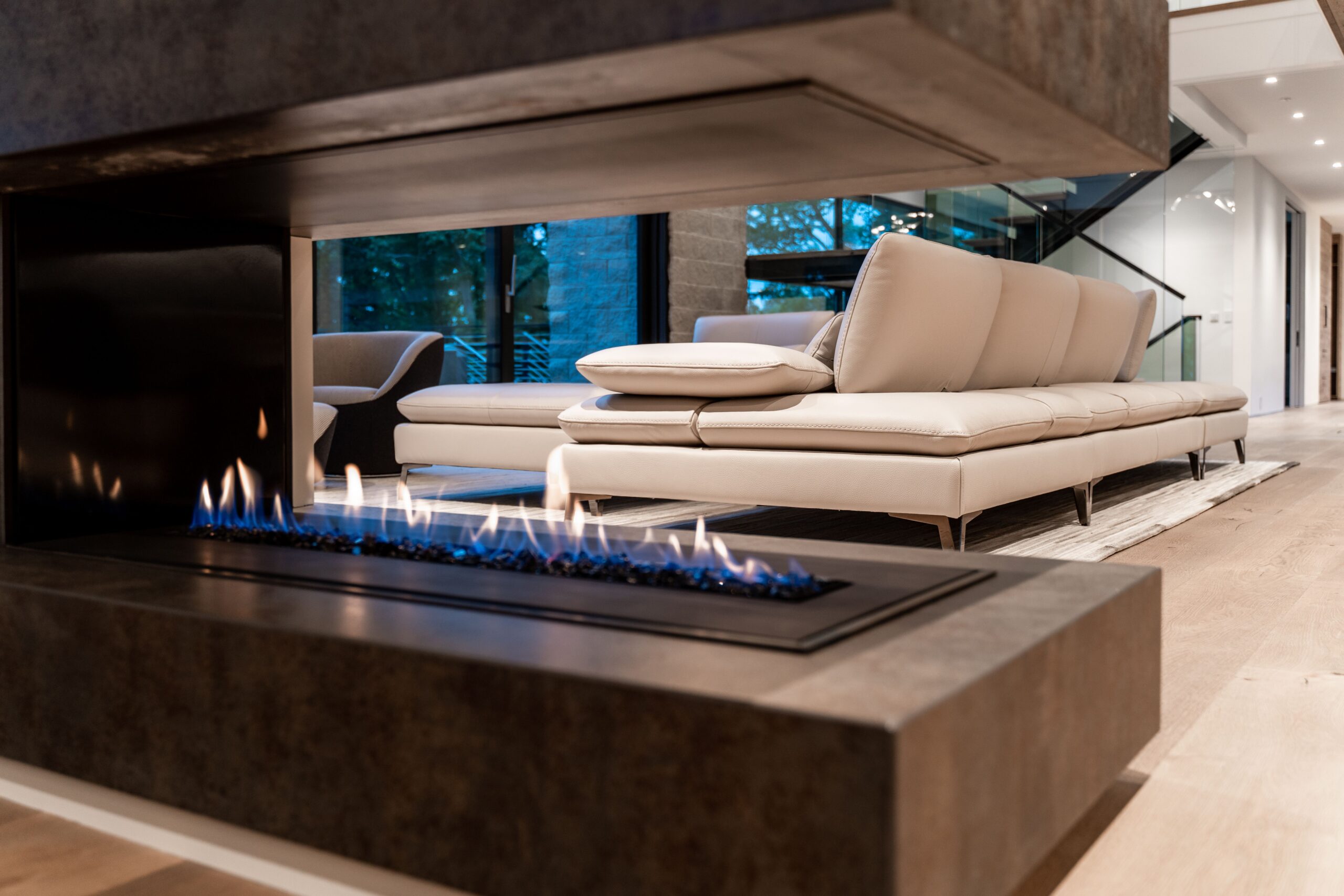 Modern fireplace in a modern home with couch in background